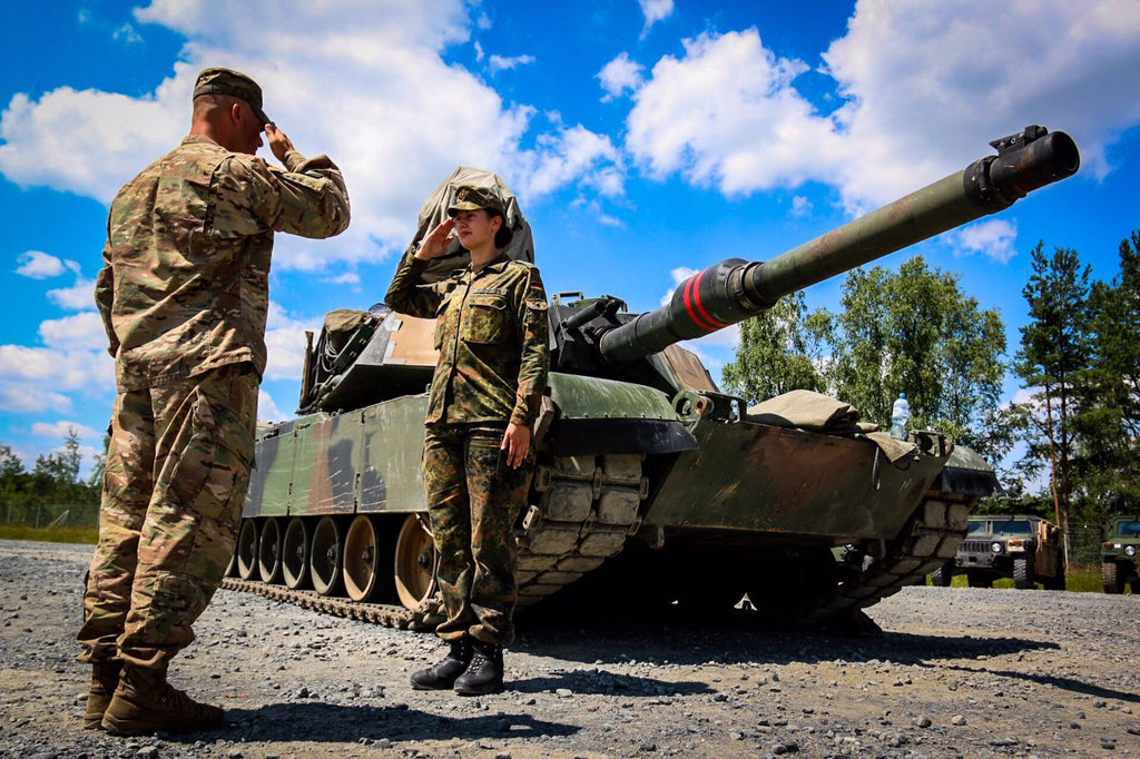 German Armor officer presents a coin to US NCO for her first salute!